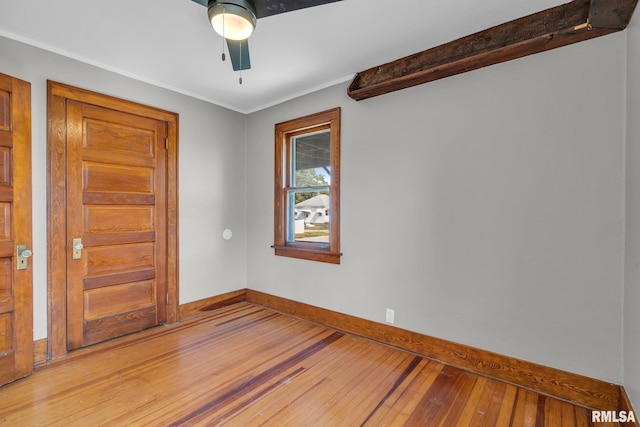 spare room with hardwood / wood-style floors, crown molding, and ceiling fan