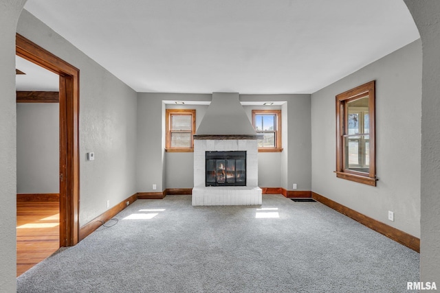 unfurnished living room with wood-type flooring and a fireplace