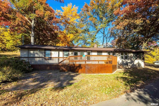 single story home with a front lawn and a wooden deck