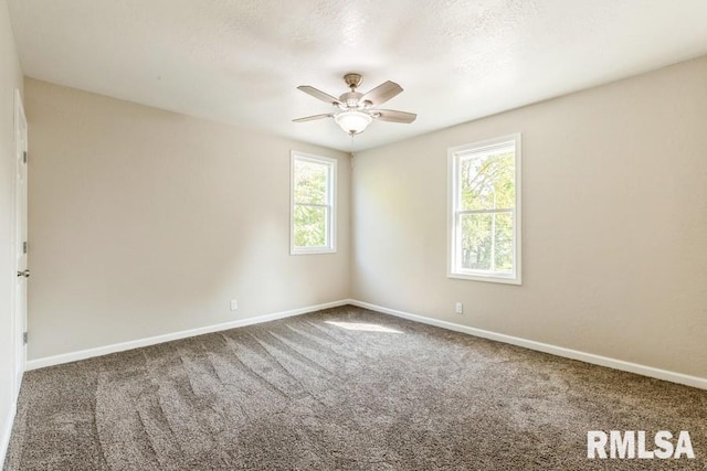 spare room featuring carpet flooring, plenty of natural light, and ceiling fan