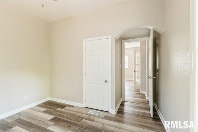 empty room with hardwood / wood-style flooring