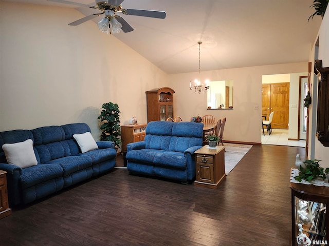 living room featuring lofted ceiling, dark wood-type flooring, and ceiling fan with notable chandelier