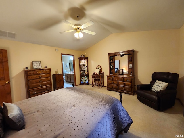 bedroom with lofted ceiling, carpet floors, ensuite bath, and ceiling fan