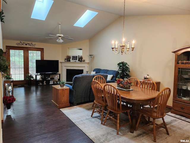 dining room with dark wood-type flooring, high vaulted ceiling, and ceiling fan with notable chandelier