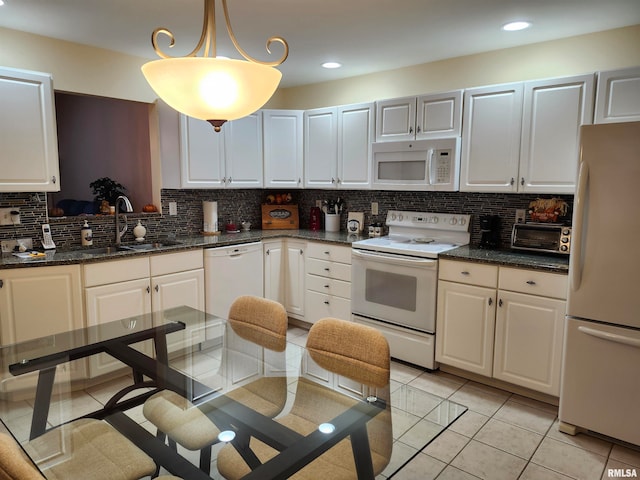 kitchen with white cabinets, hanging light fixtures, and white appliances