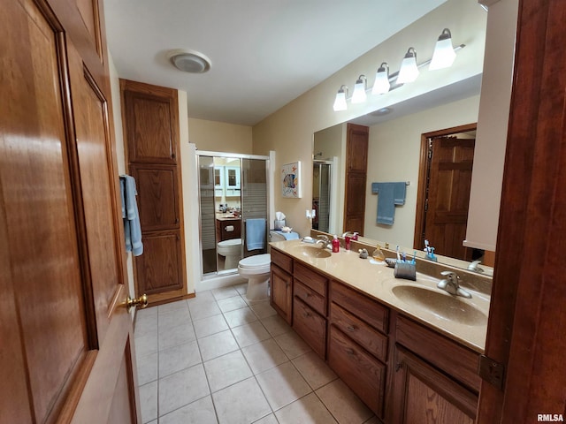 bathroom featuring vanity, tile patterned floors, toilet, and walk in shower