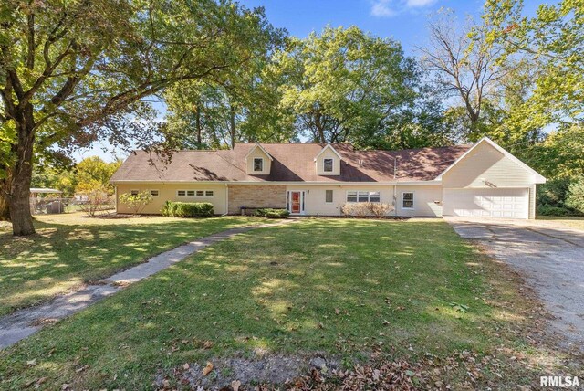 cape cod-style house featuring a garage and a front lawn