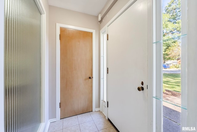 doorway to outside featuring light tile patterned floors