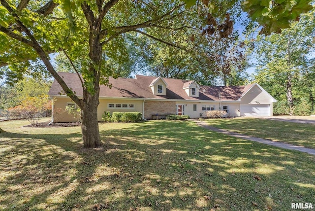 cape cod-style house featuring a garage and a front lawn