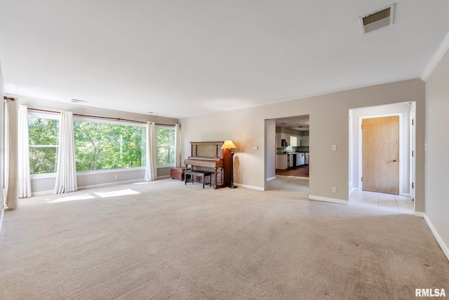 unfurnished living room with light carpet and crown molding