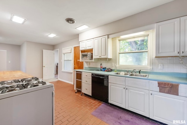 kitchen with backsplash, sink, white cabinets, and black dishwasher