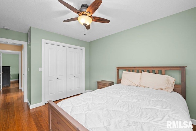 bedroom featuring hardwood / wood-style floors, a closet, and ceiling fan