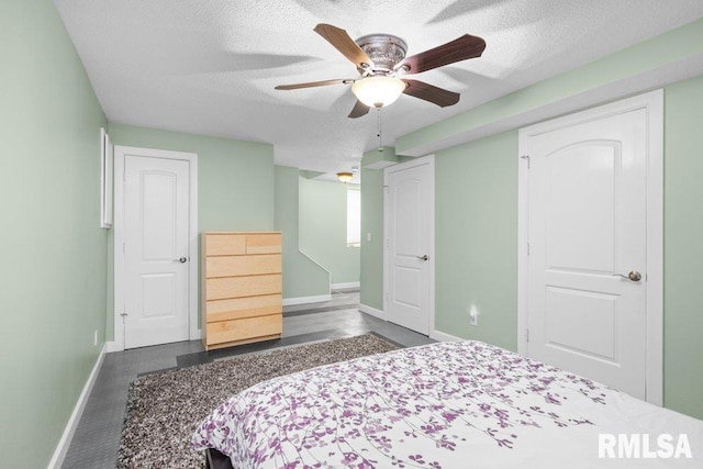 bedroom with a textured ceiling and ceiling fan