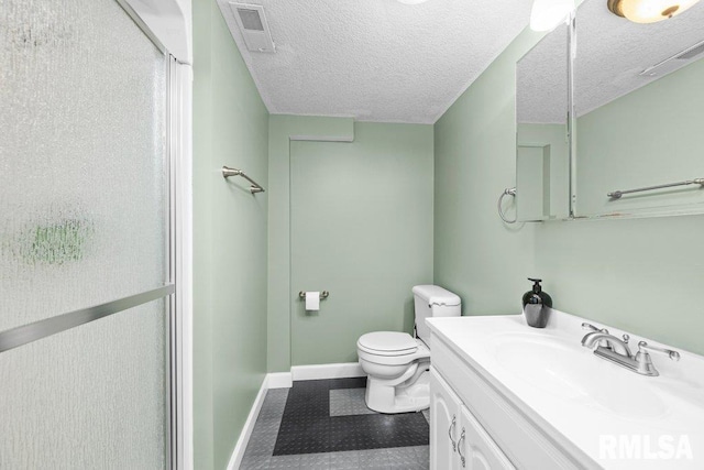 bathroom featuring vanity, a shower with shower door, a textured ceiling, and toilet