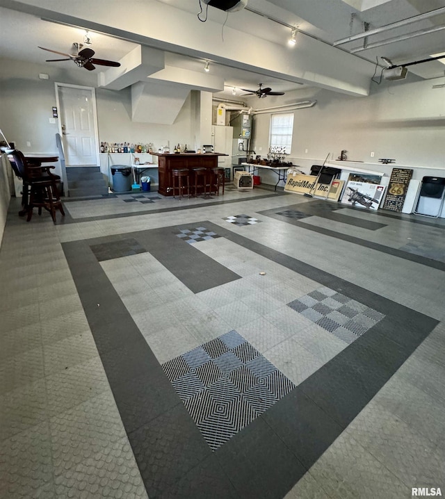 garage with a ceiling fan and a garage door opener