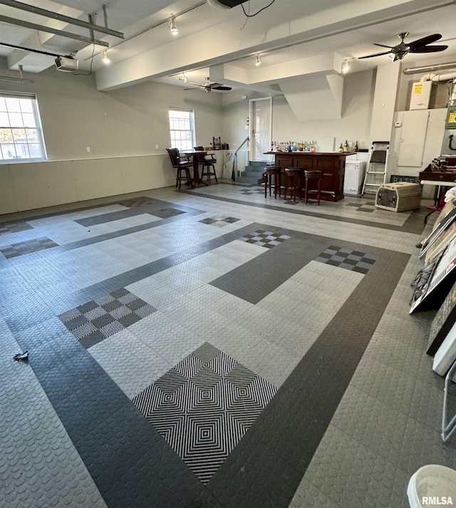 garage featuring a ceiling fan and a garage door opener