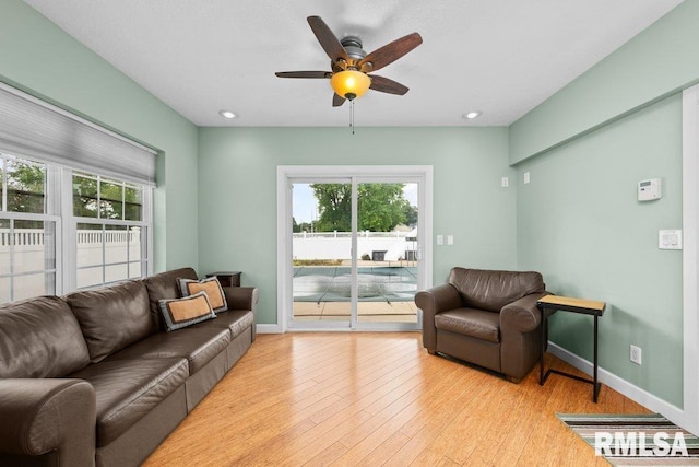 living room with a healthy amount of sunlight, light wood-type flooring, and ceiling fan