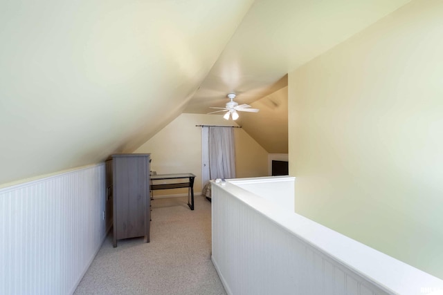 bonus room with light carpet, lofted ceiling, and ceiling fan