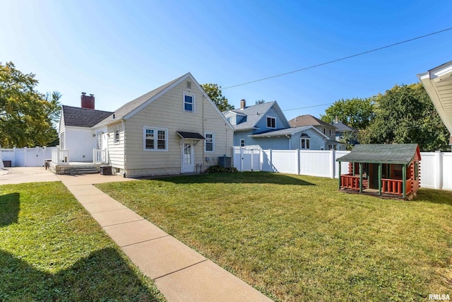 view of front of house featuring a storage shed, a front lawn, and a patio area