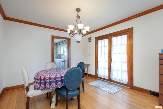 dining space featuring light hardwood / wood-style flooring, a chandelier, and a wealth of natural light