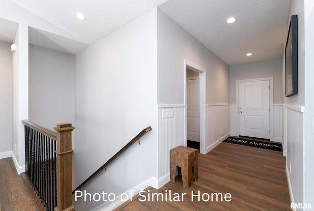 corridor with dark hardwood / wood-style flooring