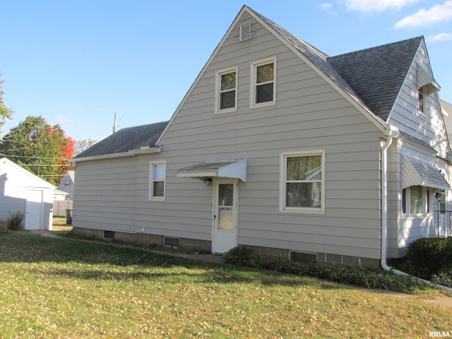 back of property featuring a lawn