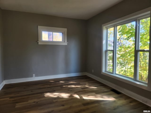 unfurnished room with dark hardwood / wood-style floors