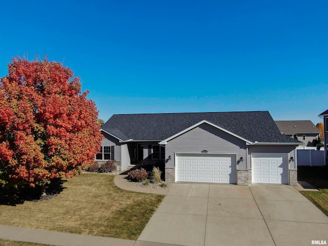 view of front of home featuring a front lawn and a garage