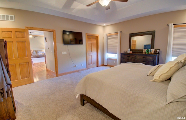 bedroom with ceiling fan and light carpet