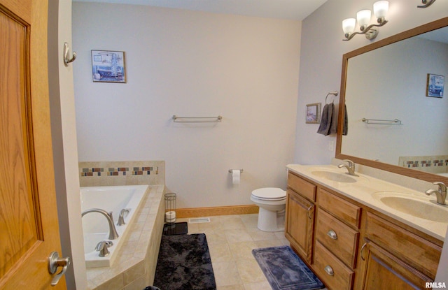 bathroom featuring vanity, toilet, tile patterned flooring, and tiled tub