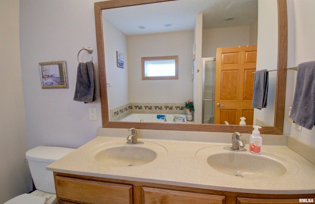 full bathroom featuring toilet, plus walk in shower, and vanity