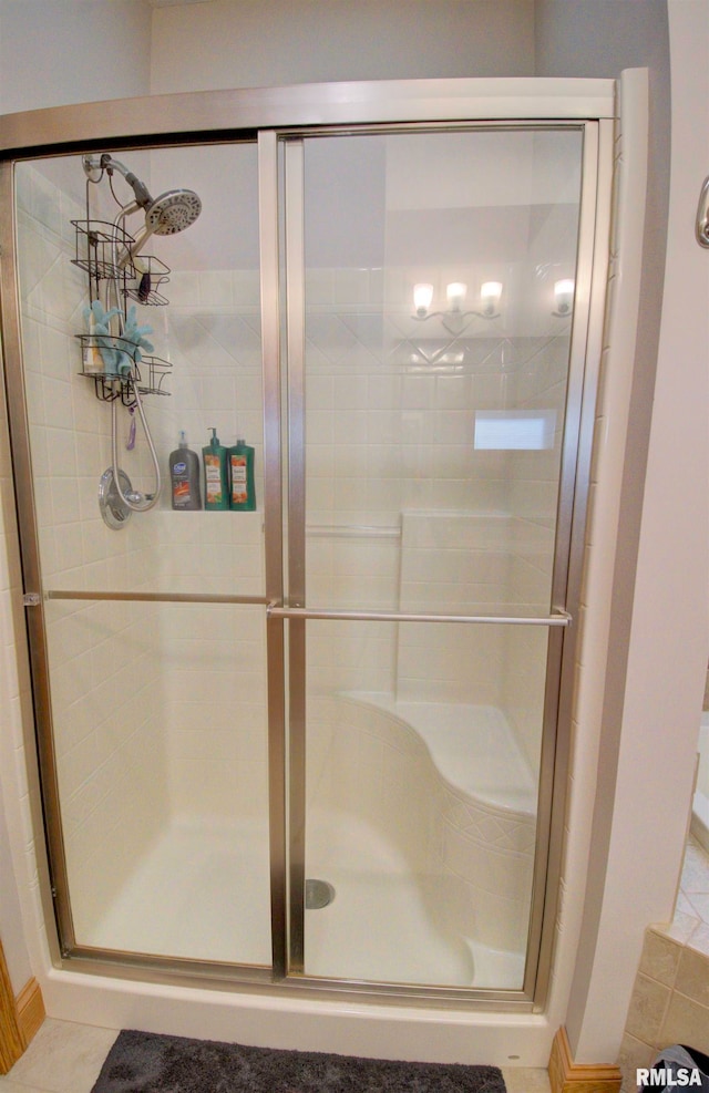 bathroom with tile patterned floors and a shower with shower door