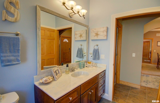 bathroom with vanity, toilet, and tile patterned floors