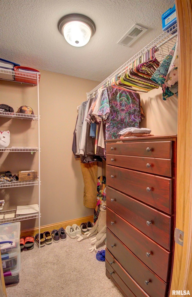 walk in closet featuring carpet floors