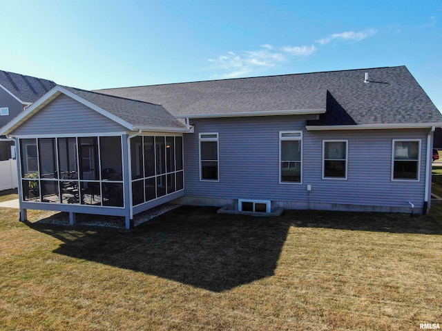 rear view of property with a yard and a sunroom