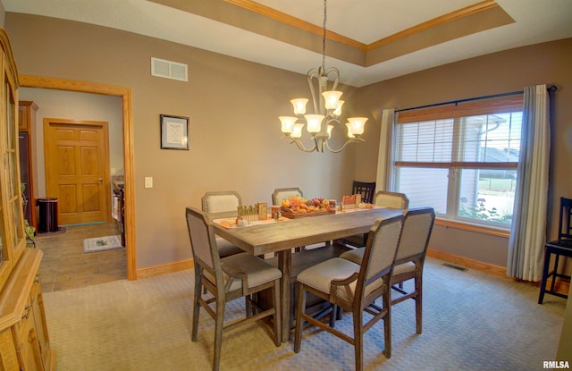 tiled dining area featuring an inviting chandelier, ornamental molding, and a raised ceiling