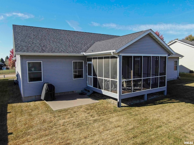 back of house featuring a yard, a sunroom, and a patio