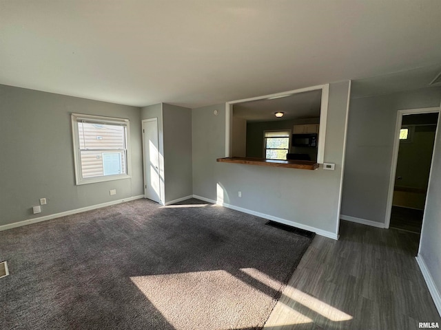 unfurnished living room featuring dark wood-type flooring