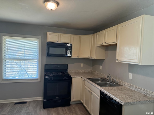 kitchen with sink, black appliances, white cabinetry, and dark hardwood / wood-style floors