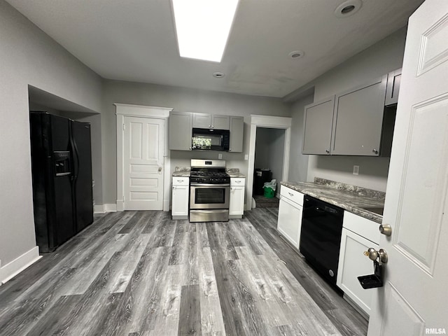 kitchen with gray cabinets, black appliances, and dark hardwood / wood-style flooring