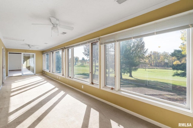 unfurnished sunroom featuring ceiling fan