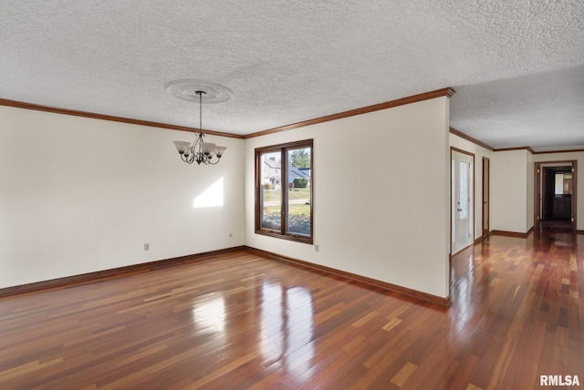 unfurnished room featuring ornamental molding, an inviting chandelier, a textured ceiling, and dark wood-type flooring