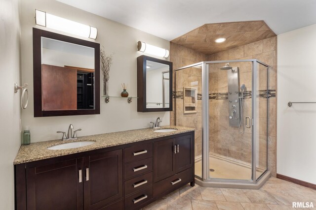 bathroom with vanity, an enclosed shower, and tile patterned floors