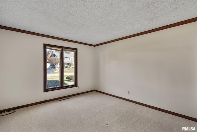 carpeted spare room with crown molding and a textured ceiling