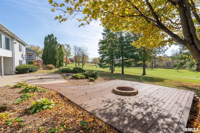 exterior space featuring a fire pit, a yard, and a deck