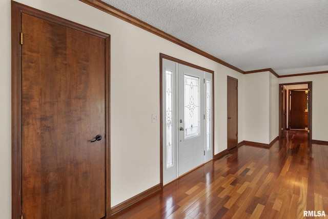 entryway featuring a textured ceiling, ornamental molding, and dark hardwood / wood-style floors