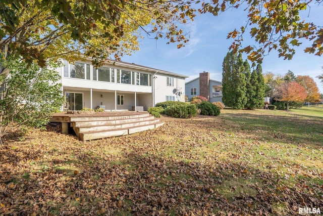 back of property with a sunroom