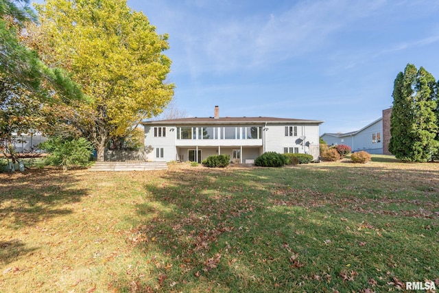 rear view of house with a yard