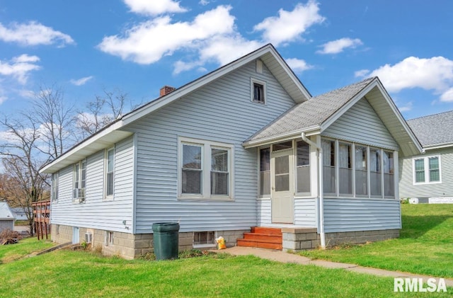 view of front of home featuring a front lawn and a sunroom