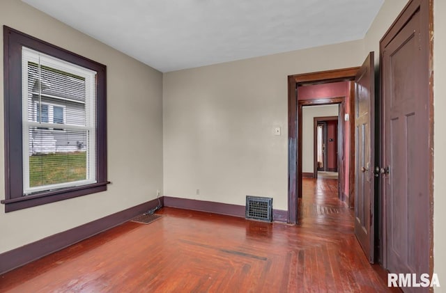 unfurnished room with dark parquet flooring